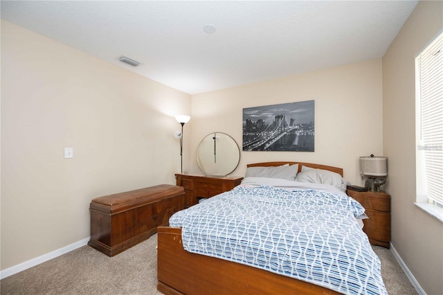 carpeted bedroom with multiple windows