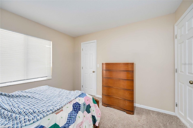 bedroom featuring light carpet