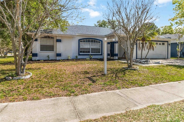 ranch-style house featuring a front lawn and a garage