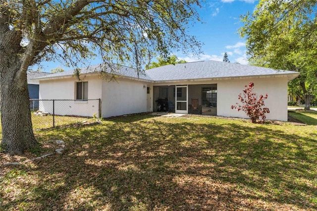 back of house featuring a yard