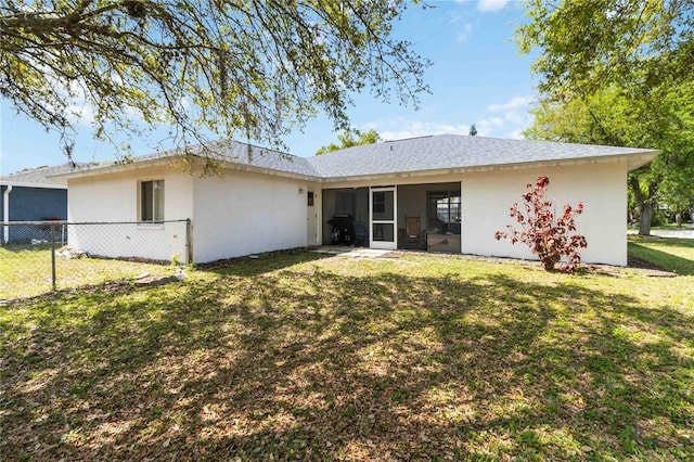 rear view of property featuring a yard