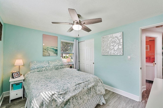 bedroom featuring ceiling fan, wood-type flooring, and a closet