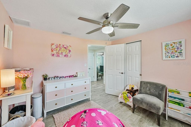 recreation room featuring ceiling fan and light hardwood / wood-style floors