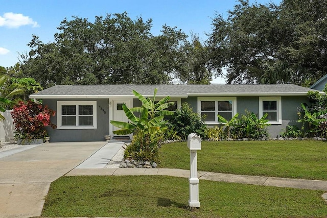 ranch-style home with a front lawn