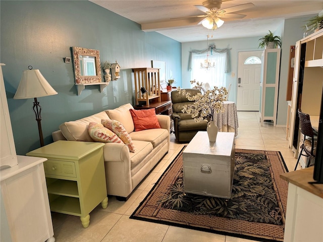 living room with ceiling fan with notable chandelier and light tile patterned floors