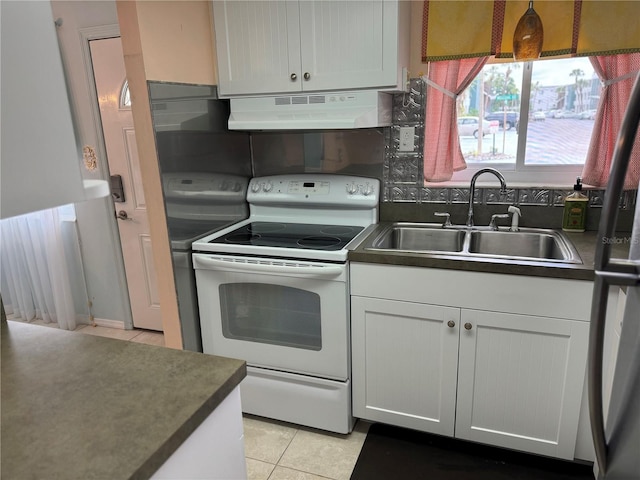 kitchen featuring white range with electric stovetop, exhaust hood, sink, and white cabinetry