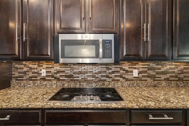 kitchen featuring dark brown cabinets, black electric cooktop, and stone countertops