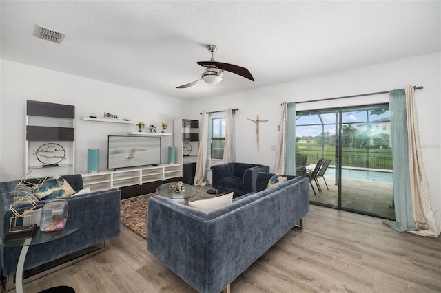 living room featuring hardwood / wood-style flooring and ceiling fan