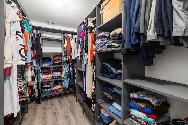 walk in closet featuring light hardwood / wood-style floors