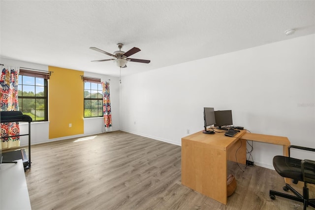 office space with ceiling fan, wood-type flooring, and a textured ceiling