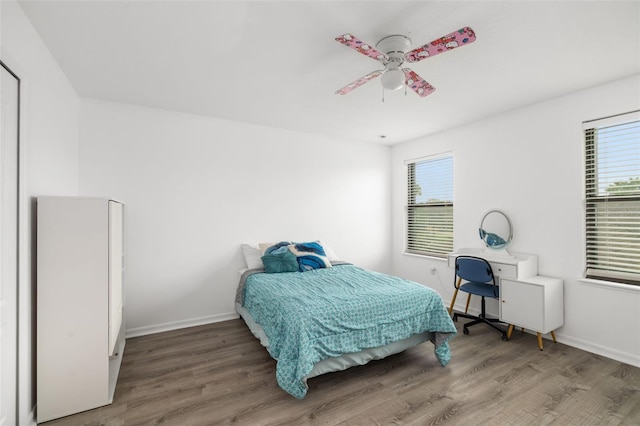 bedroom with ceiling fan and hardwood / wood-style flooring