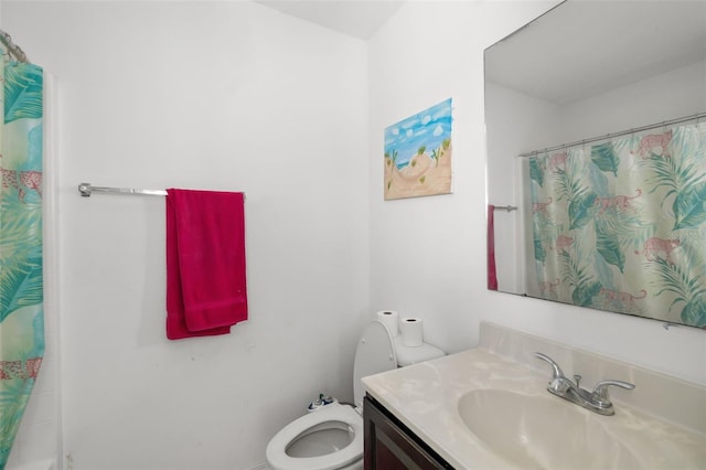 bathroom featuring vanity, toilet, and a shower with shower curtain