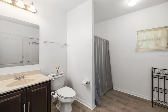 bathroom with vanity, toilet, a shower with curtain, and wood-type flooring