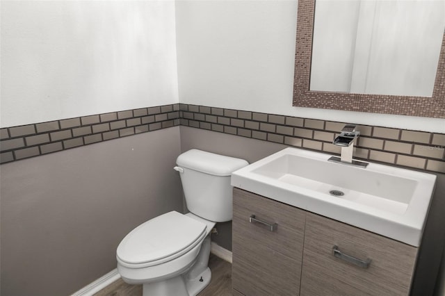 bathroom featuring backsplash, toilet, and vanity