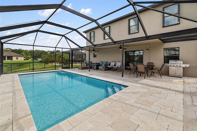 view of pool featuring glass enclosure, ceiling fan, grilling area, and a patio