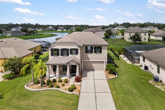 view of front of home with a garage, a front yard, a water view, and cooling unit