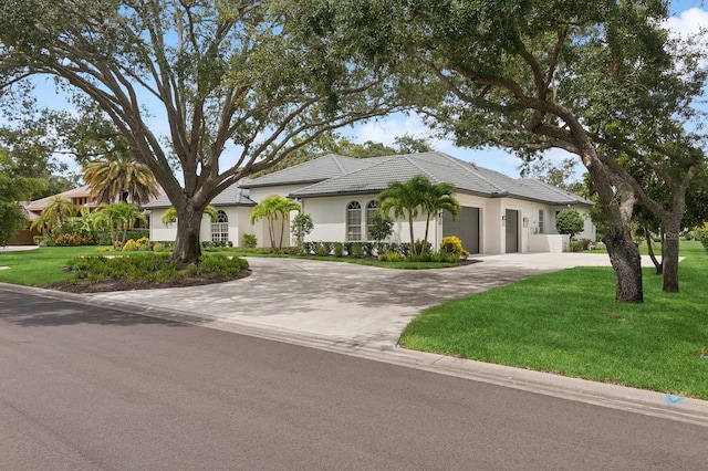 view of front of property with a garage and a front yard