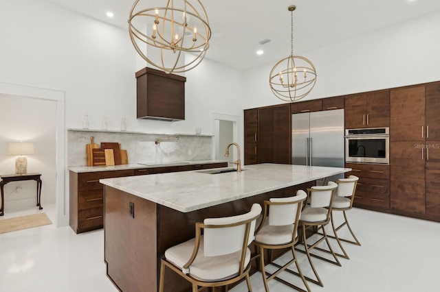 kitchen with backsplash, stainless steel appliances, an inviting chandelier, sink, and hanging light fixtures