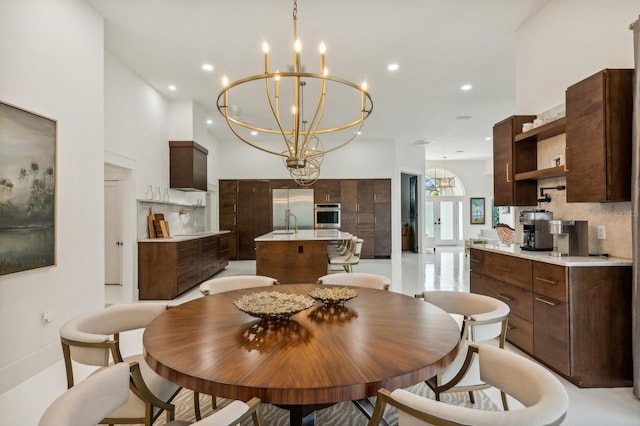 dining space featuring sink and a chandelier