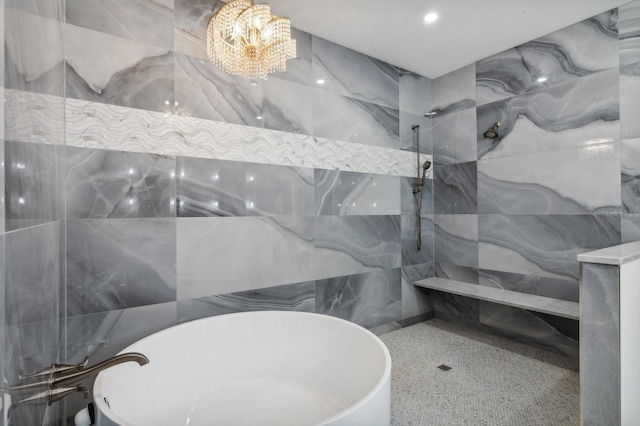 bathroom featuring tile walls, separate shower and tub, and a chandelier