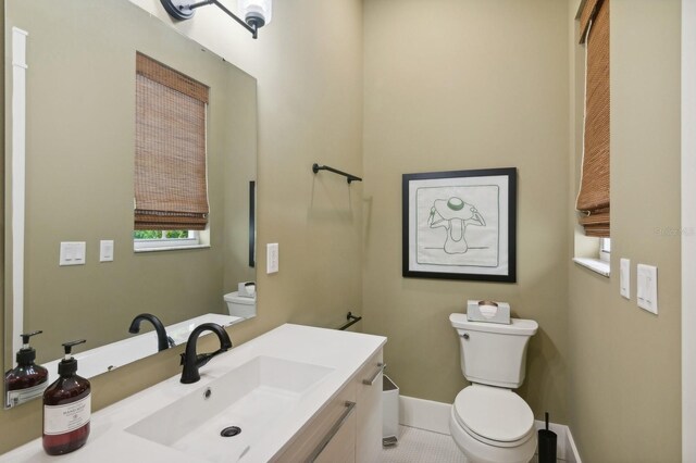 bathroom with vanity, toilet, and tile patterned floors