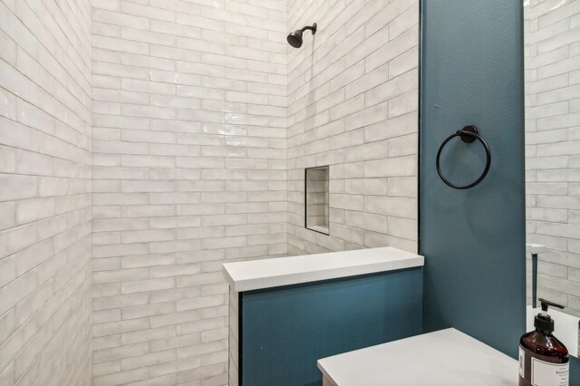 bathroom with a tile shower