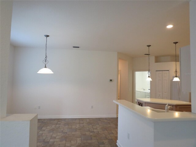 kitchen featuring a kitchen island and hanging light fixtures