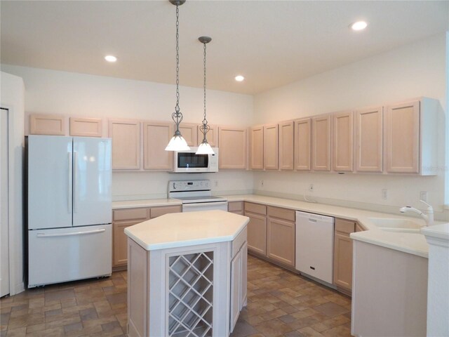 kitchen featuring pendant lighting, white appliances, a kitchen island, and sink