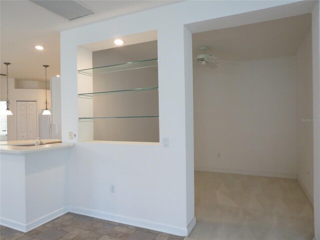 kitchen with ceiling fan and hanging light fixtures