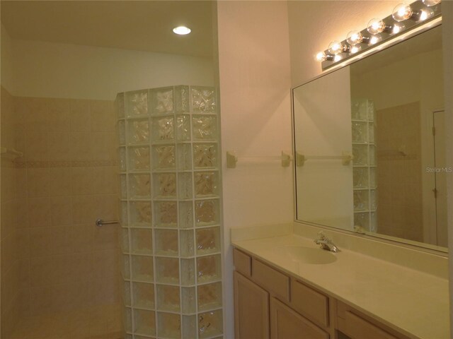 bathroom featuring vanity and tiled shower