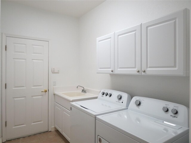 laundry area featuring cabinets, light tile patterned floors, independent washer and dryer, and sink