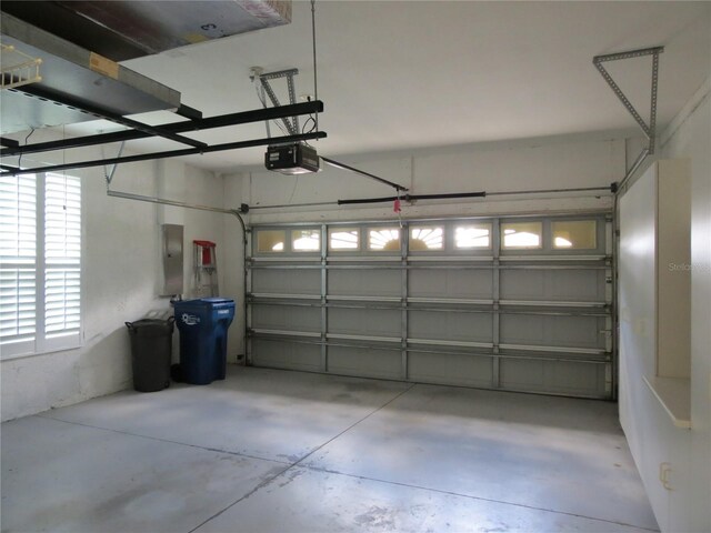 garage featuring a garage door opener and electric panel