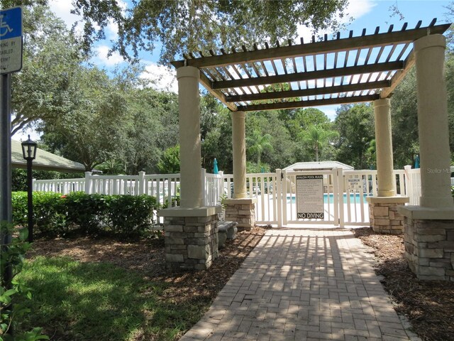 exterior space with a community pool and a pergola