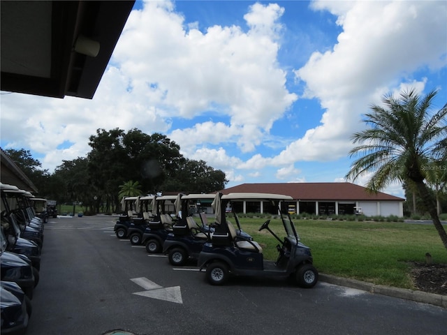 view of parking featuring a yard