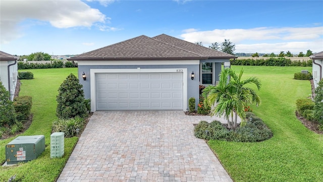 view of front of property featuring a garage and a front lawn