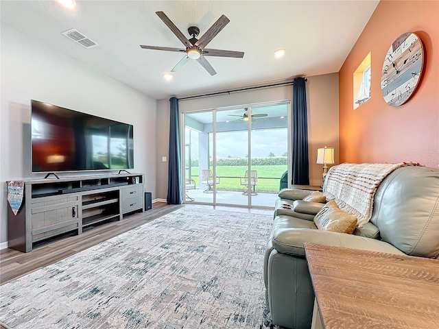 living room featuring hardwood / wood-style floors and ceiling fan