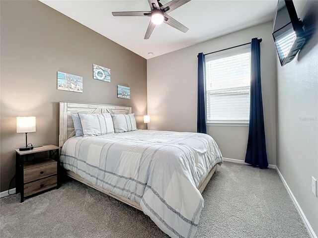 bedroom with ceiling fan and light colored carpet