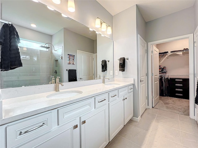 bathroom featuring tile patterned flooring, a shower with door, and vanity