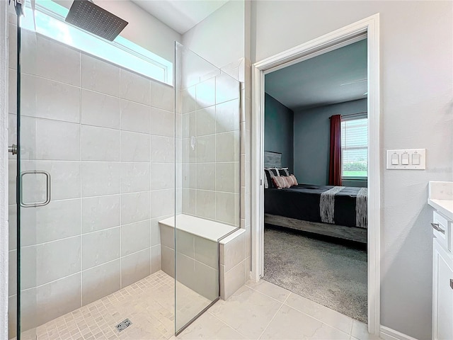 bathroom featuring a shower with shower door and vanity