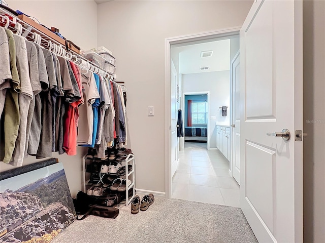 walk in closet featuring light tile patterned flooring