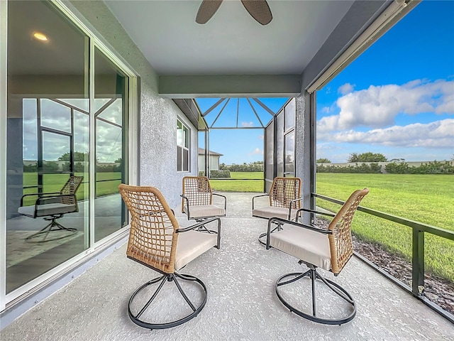 sunroom featuring ceiling fan