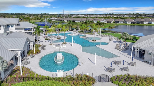 view of pool featuring a patio and a water view