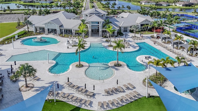 view of swimming pool featuring a water view and a patio area