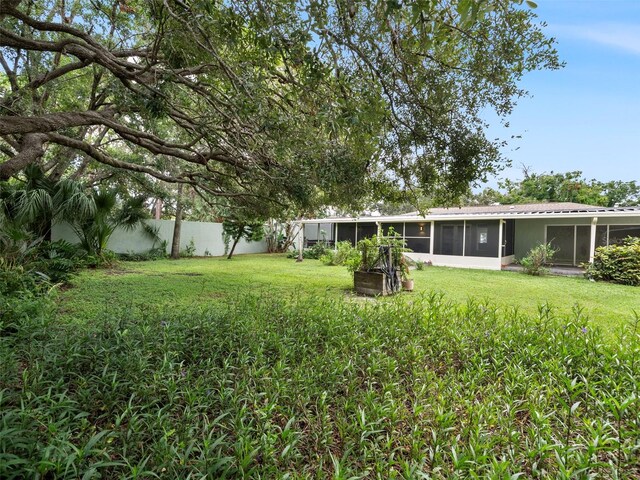 view of yard with a sunroom