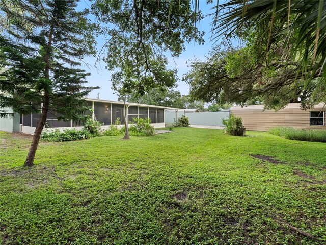 view of yard featuring a sunroom