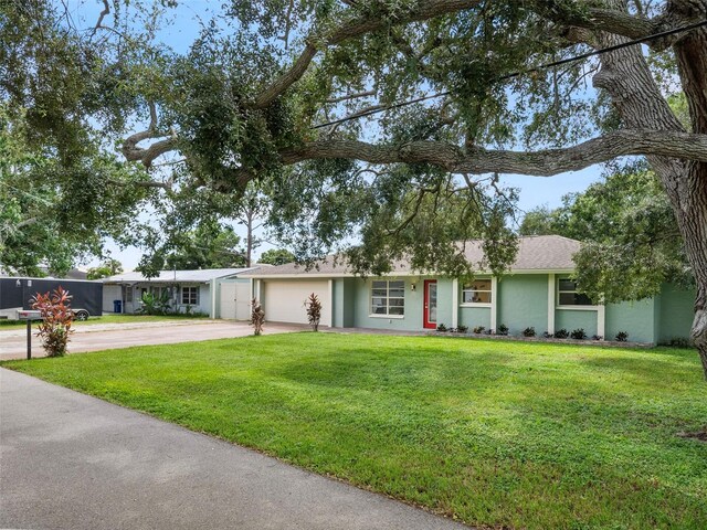 ranch-style house featuring a garage and a front lawn