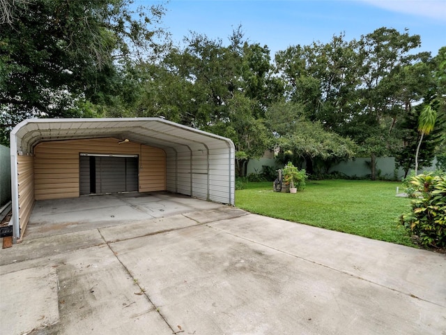 garage featuring a carport and a yard