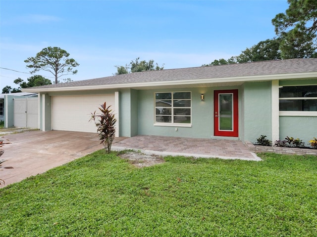 single story home featuring a front lawn and a garage