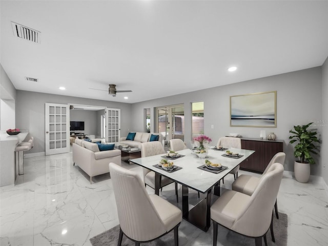 dining area with ceiling fan and french doors