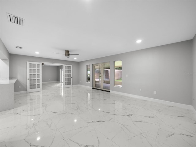 unfurnished room with ceiling fan and french doors